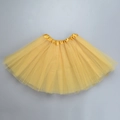 Detailed view of layered yellow mesh tulle fabric and satin waistband on the tutu skirt - Gold / Length 40cm