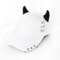 Detail of white baseball cap featuring black devil horns and silver metal ring accents - Cross Stitch White
