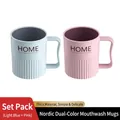 Light blue and pink plastic toothbrush cups with ergonomic handles and striped design - 2-Pack (Light Blue + Pink)