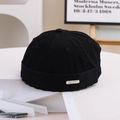 Detail of black cotton docker hat with metal nameplate and distressed frayed edge details - 55-58cm / Metal Label Style / Black