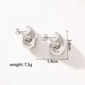 Macro shot of silver titanium hollow earrings with horizontal spiral texture detail - KC-E23 Silver Liquid Metal