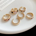 Six-piece gold geometric ring set with colorful stones displayed on a white ceramic tray - Golden Square Gemstone Style (Set of 6)