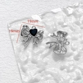 Makro-Detail von 19mm silbernen Schleifen-Anhängern mit schwarzem Herz für DIY-Schmuck - Bogen Mit Schwarzem Zirkonia