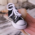 Miniature black canvas sneaker keychain with white laces and realistic rubber sole detail - Black