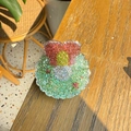 Detailed view of resin glitter hair clip with pink and yellow cupcake design - Christmas Wreath