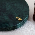 Polished gold letter W pendant with mirror finish on dark green marble base - Letter Pendant (W) / Gold