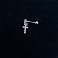 Macro view of silver cross ear cuff with sparkling zircons on a dark velvet background - Steel-Cross