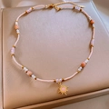 Baroque beaded necklace with a golden sun pendant and pink gemstone on a jewelry box - Pink Gold Sun Pendant Style (46#)