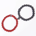 Detail of red and black magnetic couple bracelets with heart clasp and crown charms - Red Turquoise And Lava Stone