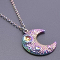 Macro detail of iridescent crescent moon pendant with celestial sun and star engraving - Pendant with Necklace / Rainbow
