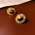 Macro view of vintage tiger eye stud earrings with ornate gold-plated hollow metal edges - Silver Pin - Brown Coffee