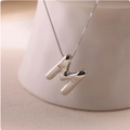 Detailed macro view of 3D bubble letter M pendant with a polished silver finish on box chain - Silver (With Necklace) M