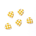 Detail of five heart-shaped enamel charms with yellow checkerboard pattern and gold edges - Gold Tone Yellow White Checkerboard Heart