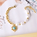 Golden titanium steel bracelet with white pearls and hollow flower turquoise charm - Turquoise Flower