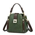 Retro dark green bucket bag with brown handles and golden twist lock on white background - Green
