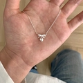 Minimalist silver butterfly necklace with heart pendant held by hand for size reference - Bowknot Heart Pendant Necklace (XL3260)