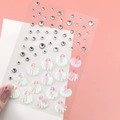 Iridescent shell and clear rhinestone face jewels sticker sheet held by hand - Iridescent Shell Rhinestones (BJA-602)