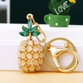 Detail of pineapple keychain with yellow opal beads, green crystals and gold plating - Single OPP Bag Packaging / White Cat Eye Pineapple