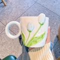 Detailed view of white ceramic tulip mug with blue petals and large circular handle - Single Cup / Blue