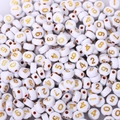 Close-up of white acrylic round beads with golden numbers for DIY jewelry making - 4x7mm White With Gold Numbers (100pcs)