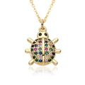 Macro shot of a golden ladybug pendant with vibrant multicolor zircon crystal inlay - Colorful Ladybug Shape (D571)