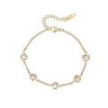 Golden stainless steel heart bracelet featuring five clear zircon stones on a white background - Gold-White Zirconia