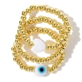 Set di tre braccialetti con perline dorate con cuore bianco e ciondolo occhio blu - Cuore e Malocchio Perline Dorate (JS-S24070303A)