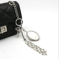 Ciondolo per borsa in argento con stella, fiocco e specchio ovale su borsa trapuntata - Portachiavi Rotondo d'Argento Stile Ovale