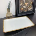Macro shot of white ceramic tray with gold beaded edge on dark tabletop surface - Gold Beaded Rectangular Serving Tray
