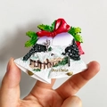 3D bell-shaped Austria souvenir magnet with snow-covered village and red bow detail - (88) Austria Snow Scene