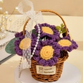 Detailed view of hand-knitted purple sunflower in basket with lace bow and pearl chain - 7 Purple Daisies Basket