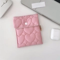 Pink quilted heart pattern storage pouch with white snap button on a desk - Heart Quilted Pink Sanitary Bag