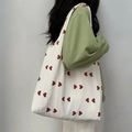Side view of white canvas tote bag with red heart patterns worn on shoulder - Vest Bag / Red Heart