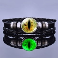 Detailed view of leather bracelet with glowing green dragon eye glass bead on mirror - Bright Green Luminous Cat Eye Style