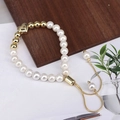 Close-up of elegant pearl bracelet with gold heart charm and adjustable pull chain - Multi-bead Heart Charm