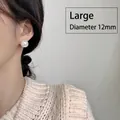 Close-up of 12mm large pearl stud earring worn by model for elegant styling - Large Pearl Stud Earrings 1 Pair