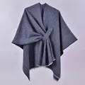 Detail of navy blue knitted poncho featuring twill weave texture and delicate fringe edges - White Fringe with Stripe / Navy Blue