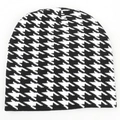 Detailed close-up of houndstooth knit pattern and black cuffed hem of the winter beanie - One Size(Elastic) / Houndstooth