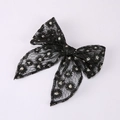 Detail of a large black lace bow hair clip with delicate white floral embroidery - Black