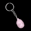 Pink crystal grenade pendant keychain with silver metal ring on black background - Rose Quartz