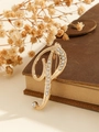 Elegant gold letter P brooch with white rhinestones on a vintage leather book - Gold Letter P