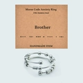 Macro shot of Morse code fidget beads on 316L stainless steel ring with Brother card - Brother