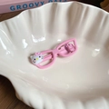 Detail van roze bril haarclip met schattige cartoon kat op wit schelpvormig schaaltje - Brilvormige Eendenbek Clip / Roze