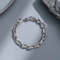 Sleek silver stainless steel chain bracelet for men displayed on a gray textured stone - Minimalist Steel Chain