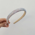 Close-up of shimmering AB crystals hand-set on a wide baroque style padded headband - AB Rainbow