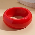 Detail of glossy bright red resin chunky bangle with elegant geometric round design - Red