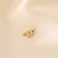 Golden micro-pave pendant featuring the letter F with zircon stones on silk fabric - Letter F / Gold