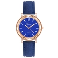 Detailed view of blue quartz watch with faceted rose gold case and leather strap - Blue