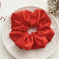 Vibrant red large satin scrunchie with silky finish on an elegant white textured plate - Large Bright Red