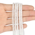 Detail of white translucent spacer beads strings held in hand for jewelry making - 150 Pieces / White Stone